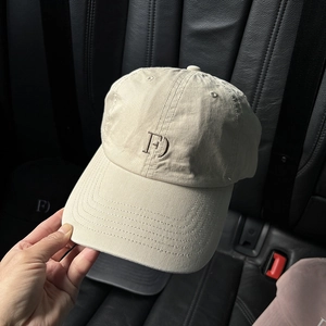 Detail of beige washed cotton baseball cap featuring F embroidery and curved brim