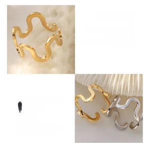 Macro detail of U-shaped wave rings in gold and silver finish made of 18K titanium steel