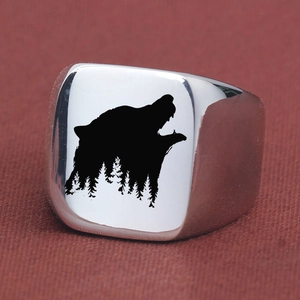 Detail shot of vintage square wolf and forest silhouette laser engraving on silver ring