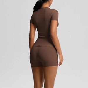 Detail view of the back and side of a dark brown yoga set featuring a sleek athletic fit