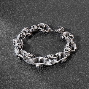 Detailed macro view of double-layer skull links on a gothic stainless steel bracelet