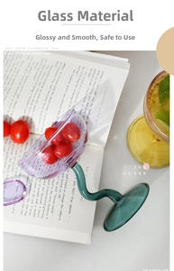 Artistic purple glass bowl with green wavy stem used as a cherry tomato serving dish
