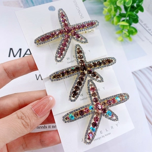 Three-piece set of starfish alloy hair clips with colorful crystals on display card