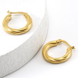 18K gold-plated stainless steel twisted hoop earrings on a white stone pedestal