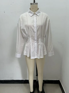 Detailed view of white long-sleeve shirt with waist pleats and button-up front design