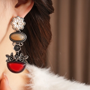 Detailed shot of vintage silver flower earrings with amber and ruby red stone drops
