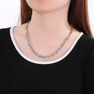 Polished stainless steel infinity symbol chain necklace shown on a model neck