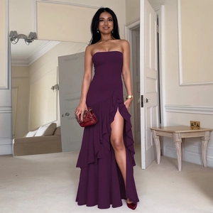 Detail of dark purple strapless evening dress with tiered ruffles and high split