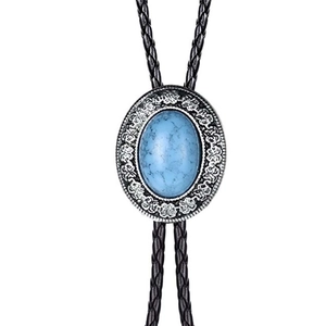 Close-up of blue turquoise bolo tie with silver floral engraving on black leather cord