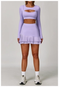 Front view of lilac high-waisted pleated sports skirt and matching long sleeve crop top