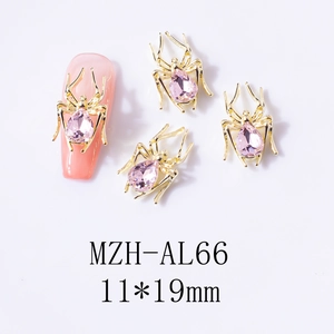 Detailed view of 3D gold spider nail art charm with pink teardrop crystal 11x19mm
