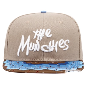 Detail of THE MUNCHIES embroidery and doughnut pattern brim on khaki flat peak cap