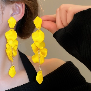 Close-up of elegant yellow layered rose petal tassel earrings worn by a female model