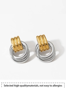 Macro detail of two-tone gold and silver layered earrings with textured finish