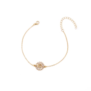 Detailed close-up of a gold sunflower bracelet featuring a dainty butterfly motif pendant
