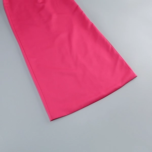 Detail of rose pink smooth fabric and high-quality hem on a slim-fit evening gown