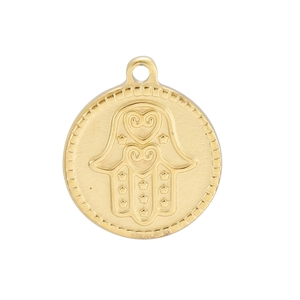 Macro shot of golden round metal pendant with detailed Hand of Fatima and heart engraving