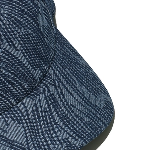 Detail of denim baseball cap showing premium jacquard texture and wavy stripe patterns
