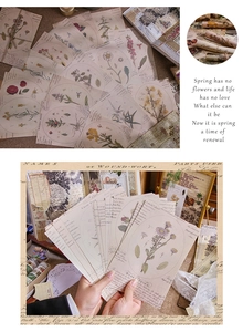 Close-up of vintage floral scrapbooking paper with botanical illustrations and aged texture
