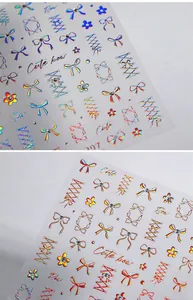 Macro detail of laser holographic bow and flower nail stickers with 3D colorful effects
