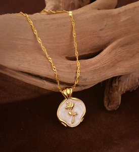 Detailed close-up of golden rose relief pendant with white marble enamel finish