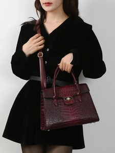 Deep red crocodile embossed leather handbag with metal turn-lock and adjustable shoulder strap