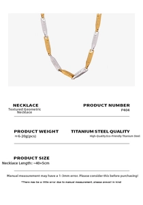 Detailed macro view of gold and silver tone steel necklace with Greca pattern on clasp