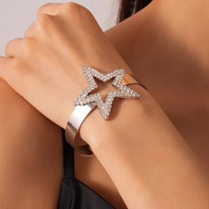 Detailed view of silver star cuff bracelet with sparkling white crystal pavé setting