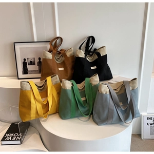 Multiple colorful canvas tote bags on white pedestals for daily casual fashion