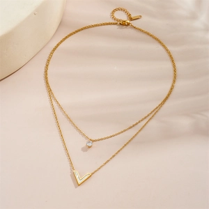 Macro view of double-layered 18K gold-plated V-pendant necklace with a zircon stone detail