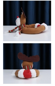 Side and back view of a plush reindeer curtain tieback with festive striped scarf