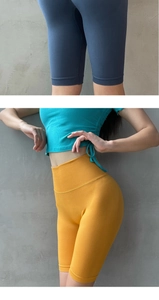 Macro detail of high-waist seamless yoga shorts with compression and elastic fabric textures