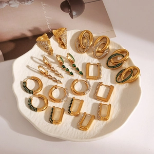 Detailed display of 18k gold plated geometric earrings with green and white zircon stones