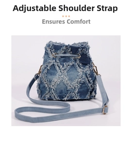Detail of adjustable shoulder strap and gold hardware on tie-dye denim bucket bag