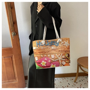 Detail of beach themed canvas tote bag with rope handles and oil painting style holiday print