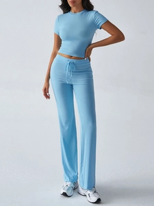 Detail view of light blue short sleeve T-shirt and high waist drawstring trousers set