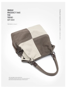 Detail of color-block canvas tote bag with metal ring attachments and reinforced stitching