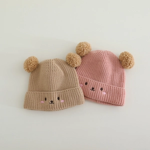 Cute baby winter knit beanies with bear ear pom-poms and cartoon embroidery in beige and pink