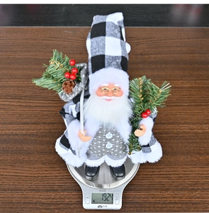 Standing Santa Claus doll decoration with grey vest weighing 192.4g on a digital scale