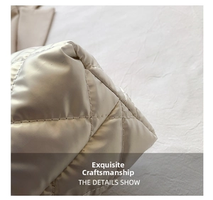 Detailed close-up of quilted diamond stitching on soft white padded tote bag texture