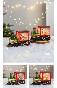 Christmas train snow globe lantern detail view showing festive snowman and Santa Claus.