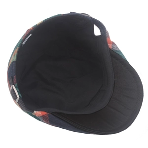 Close-up of colorful plaid flat cap interior with black lining and metal buckle