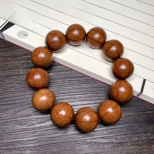 Macro shot of natural wood grain detail on Buddhist prayer beads with Zen background