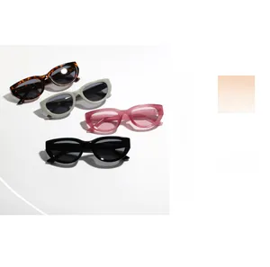Close-up of vintage cat eye sunglasses in tortoise, grey, pink, and black colors