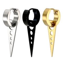 Close-up of punk style triangle pendant earrings in silver, black and gold finishes
