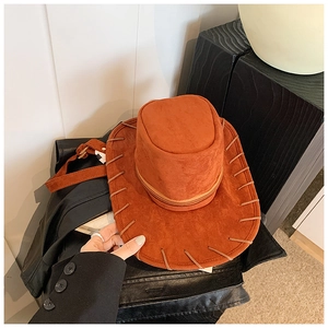 Close-up of caramel woven western cowboy hat with brown braided stitching detail
