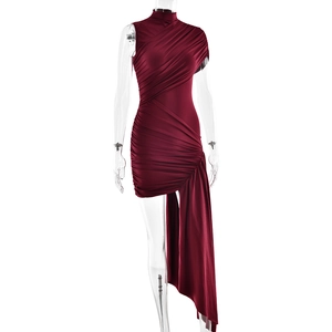 Detail of burgundy ruched fabric and asymmetric hem on a high-neck sleeveless dress