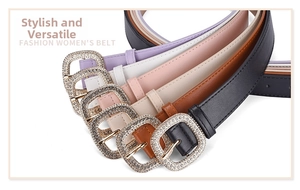 Detail view of colorful leather belts with sparkling rhinestone-encrusted square buckles