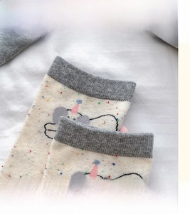 Detail view of high elastic gray knit cuff with minimalist cartoon elephant design