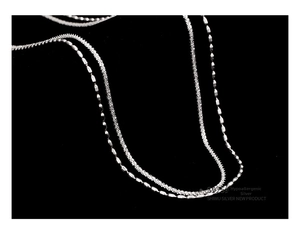 Detailed macro view of S925 sterling silver double layer chain with hypoallergenic texture